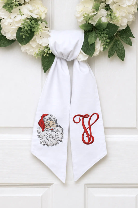 Personalized st. nicholas wreath sash with embroidered motif for a decorative front door wreath; styled view