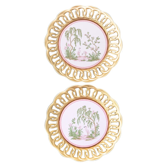 Pair of gold scalloped wall plates with pink centers and embroidered green and pink chinoiserie heron garden scenes