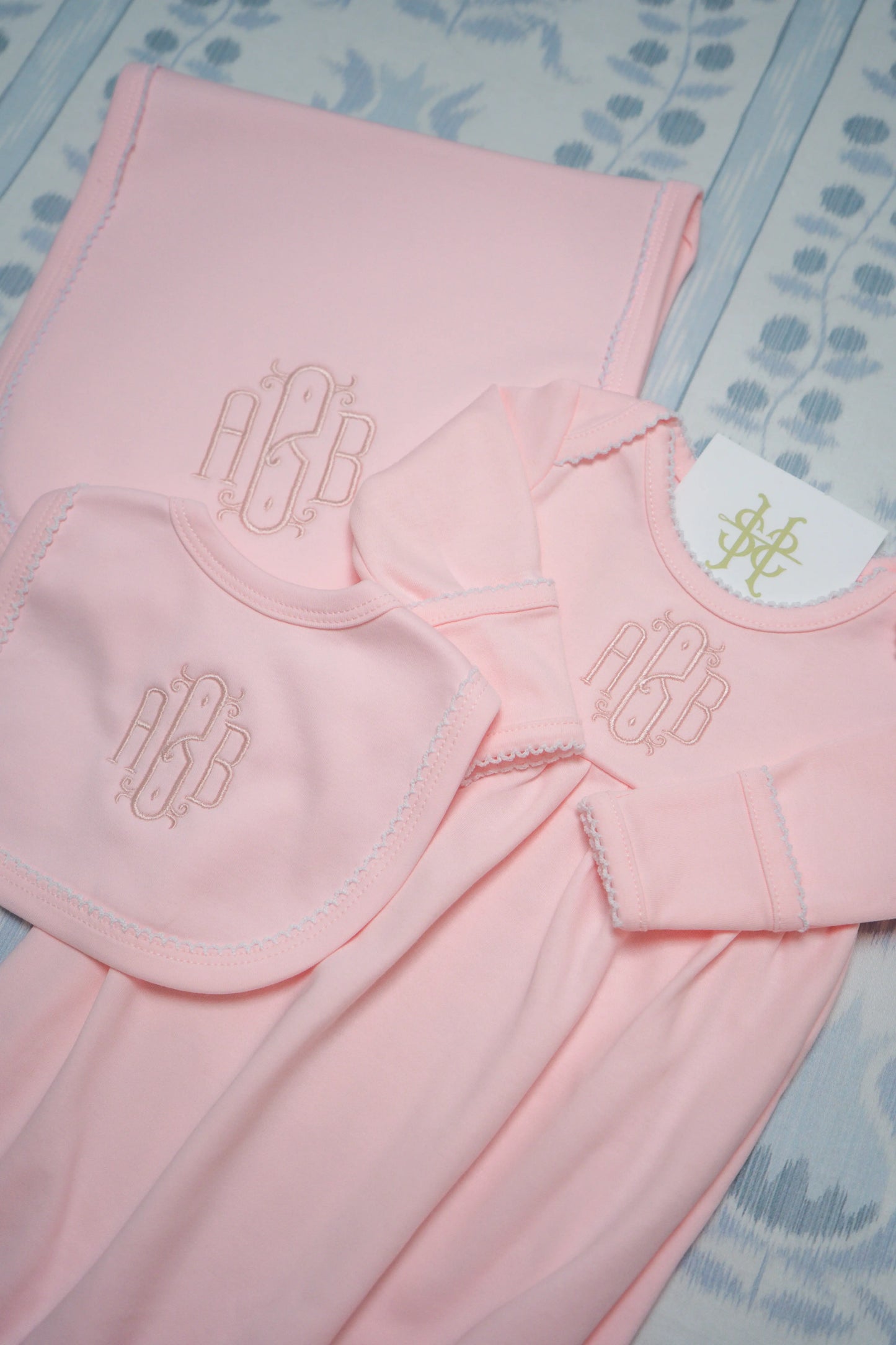 Personalized picot trim gown, bib, and burp cloth bundle with custom embroidery for a newborn outfit; embroidery detail