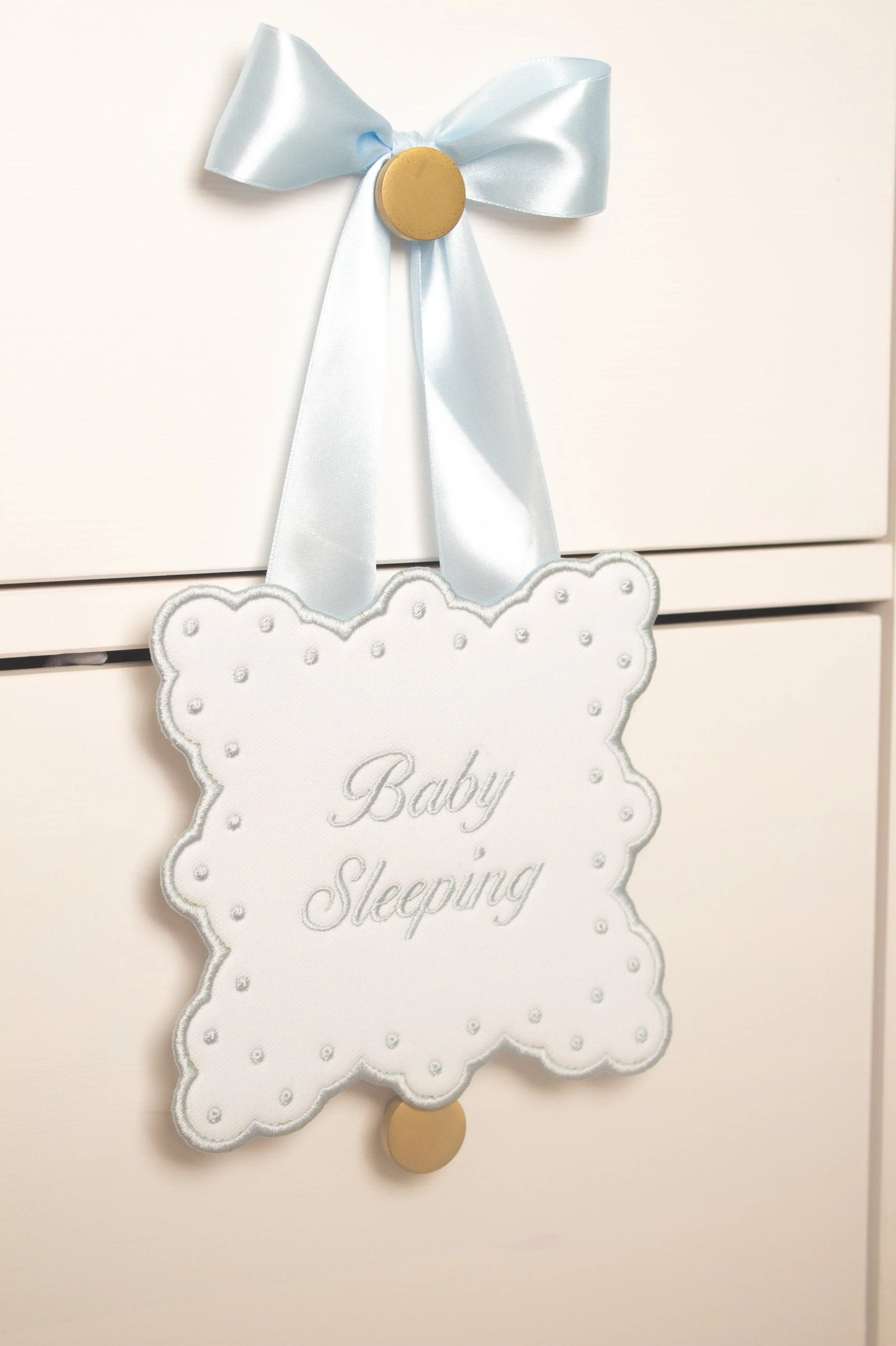 Personalized sleeping baby door sign with custom embroidery from Saul Stitch House; embroidery detail