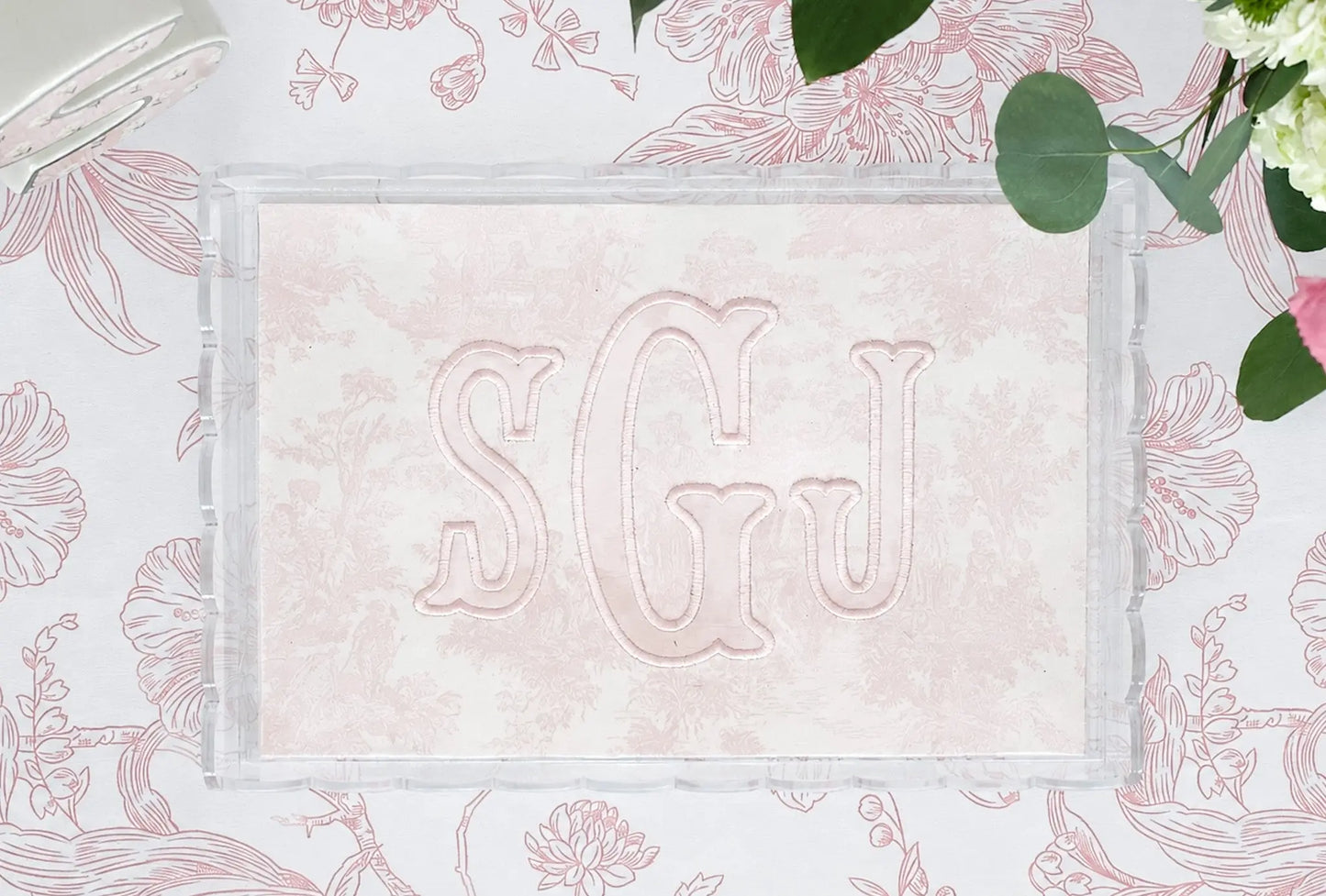 Clear scalloped acrylic nursery tray with pink toile fabric and embroidered SGJ appliqué monogram