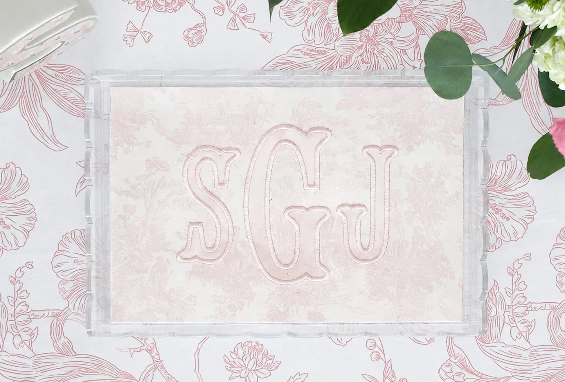 Clear scalloped acrylic nursery tray with pink toile fabric and embroidered SGJ appliqué monogram