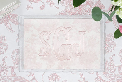 Clear scalloped acrylic nursery tray with pink toile fabric and embroidered SGJ appliqué monogram
