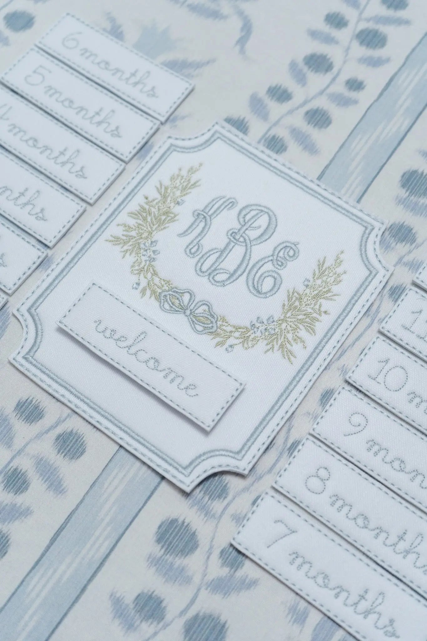 Personalized windsor monthly milestone plaque with embroidered monogram for baby milestone photos; styled view