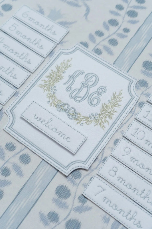 Personalized windsor monthly milestone plaque with embroidered monogram for baby milestone photos; styled view