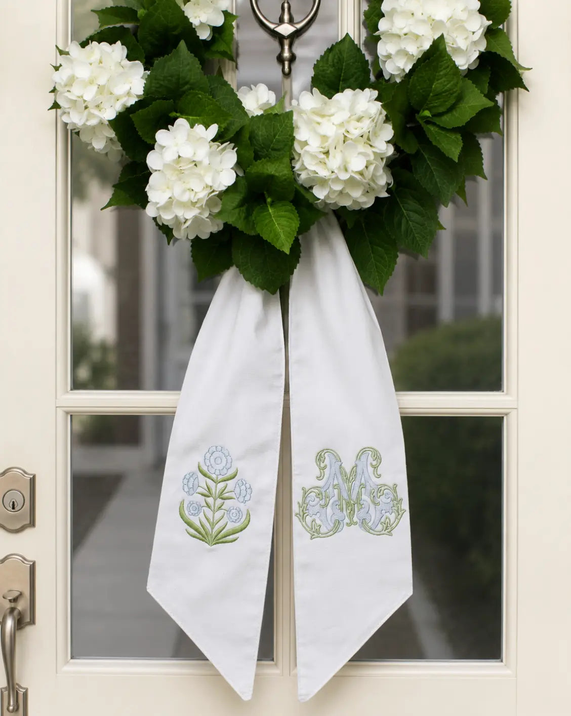 Personalized block print floral wreath sash with embroidered motif for a decorative front door wreath; embroidery detail