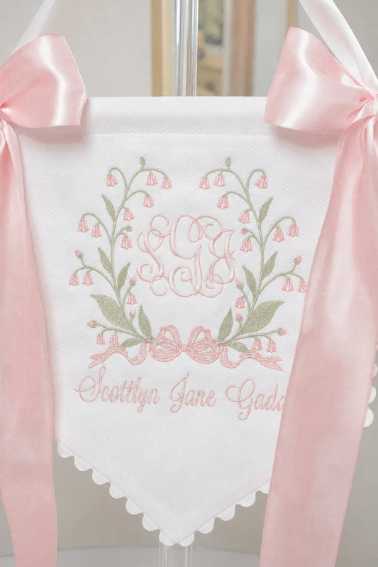 White Bell Flower Baby Banner with pink ribbons, embroidered floral crest, monogram, and personalized baby name