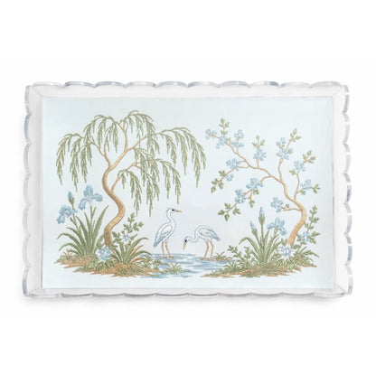Clear scalloped acrylic tray with embroidered chinoiserie garden scene, two white herons, trees, and blue flowers